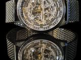 a close up of a watch with a reflection on a black surface