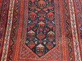 an antique persian rug with a blue and red design