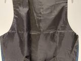 the back of a black vest with blue trims on a hanger