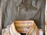 shirt and tie laid out on a wooden table with a folded shirt