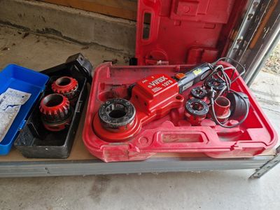 a red tool box with tools in it on a table