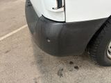 a white truck parked in a parking lot next to a building