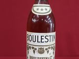 a bottle of bourbon sitting on top of a red table