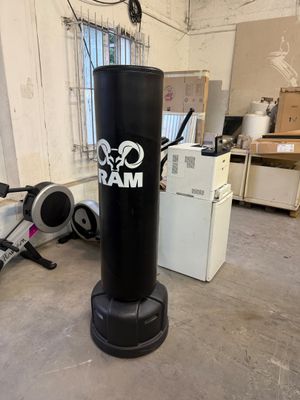 a black punching bag in the middle of a room