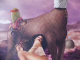 a painting of a woman laying down next to a cow