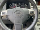 dashboard of a car with a steering wheel and dashboard gauges