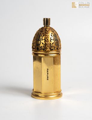 a gold colored bottle with a lid on a white surface