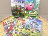 three nintendo wii games sitting on top of a wooden table