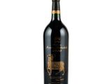 a bottle of red wine with a black label on it