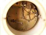 a close up of a clock that is in a white box