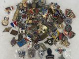 a pile of pins and other items on a table