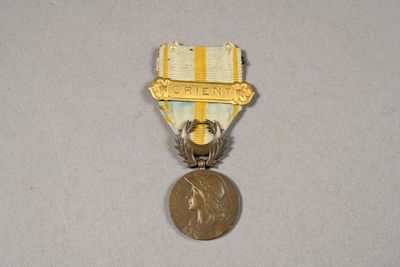 a small medal with a gold medal on top of it