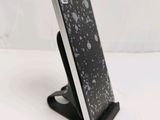 a cell phone that is on a stand on the table