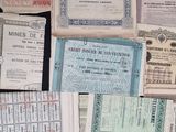 several old paper money bills are stacked on a table