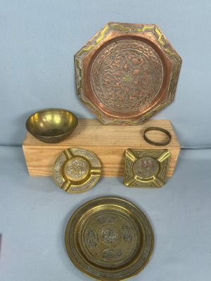 a wooden stand with a plate, bowl, spoon, and other items on it