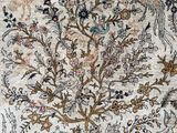 a close up of a rug with a tree of life on it