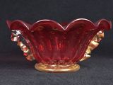 a red glass bowl on a black background