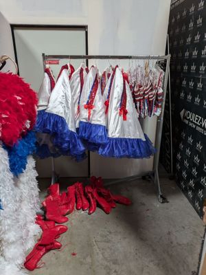 several red, white and blue pom poms are on display in a room