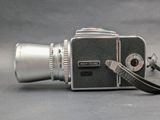 an old camera with a leather strap on it