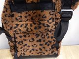 a brown and black animal print bag on a table