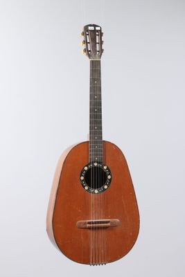 an image of a guitar hanging from a string on a wall