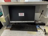 a desk with a computer and a keyboard on it
