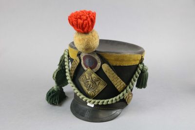 an image of a toy soldier ' s hat with a red pom pom on top of it