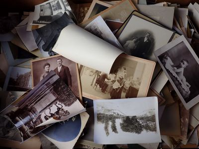 a pile of old photos that are on a table