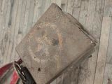 a piece of luggage sitting on the floor next to a suitcase