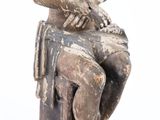 a statue of a man sitting on a chair