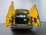 the back of a yellow van with its doors open in a room