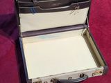 a suitcase that has a key in it on a table