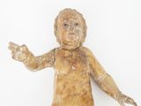 a wooden doll that is sitting on a white surface