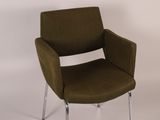 a brown chair that is sitting on a white surface