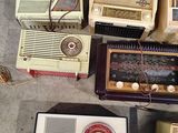 a lot of old radio ' s that are on the floor