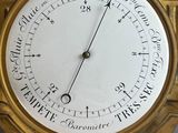 a gold clock with a roman numeral on the face