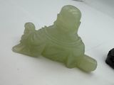 a small statue of a man sitting on top of a turtle