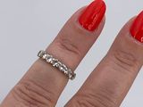 a woman ' s hand with a red manicure and a diamond ring