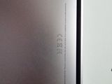 the back of a silver laptop computer sitting on top of a table