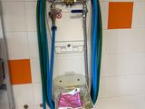 a toilet with a hose attached to it in a bathroom
