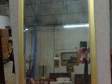 a mirror that is sitting on a table in a room