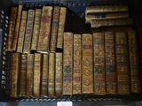many old books in a plastic container on a table