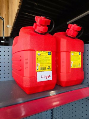 two red jerry cans sitting on a shelf in a store