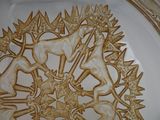 a plate with a design on it that has a horse and deer on it