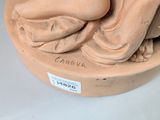 a statue of a woman laying down on a plate