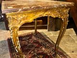 a wooden table with a marble top on a rug