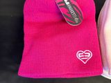 pink and white beanie hats with a heart on the front