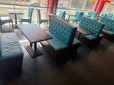 tables and chairs in a restaurant with a view of the city
