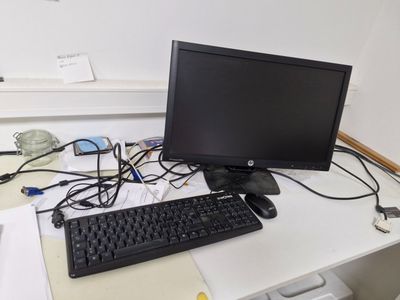 an image of a computer desk with a keyboard and monitor