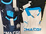 two soccer shirts are sitting next to each other on a table